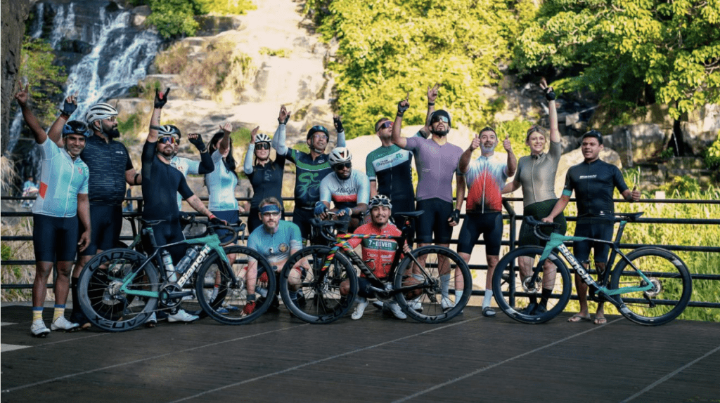 Across Ceylon. - Cycling in Sri Lanka - Cyclist group standing in front of Ravana falls